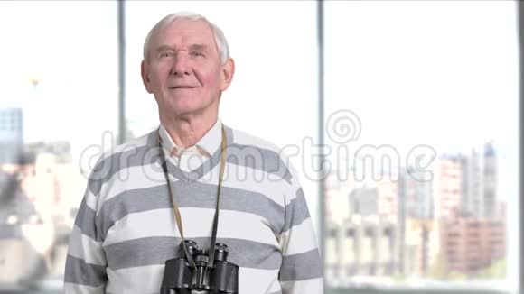 戴着望远镜摆姿势的老人视频的预览图