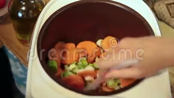 女人用手在多科克里搅拌蔬菜视频的预览图