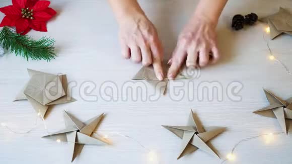 女性手折折纸明星圣诞装饰的时间流逝视频的预览图