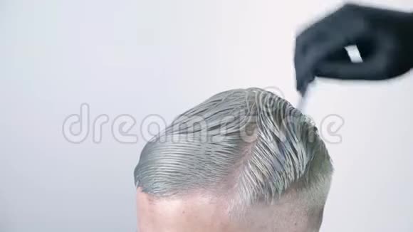 在白色背景上用剪刀剪发的男人视频的预览图