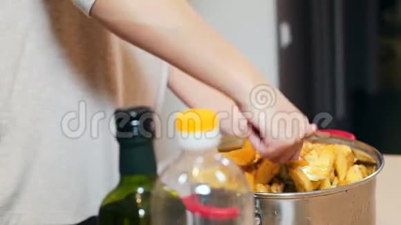 特写女性手在平底锅中混合土豆视频的预览图