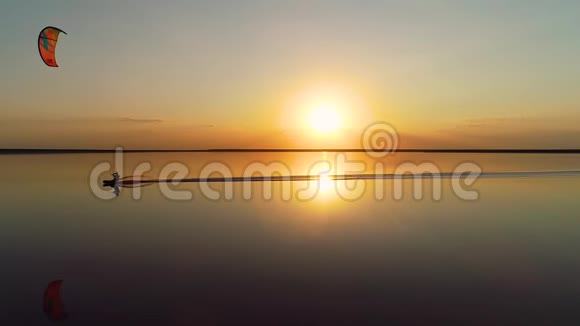 慢镜头拍摄从无人机拍摄一个人在赤鸢上滑行在平静的湖面上视频的预览图