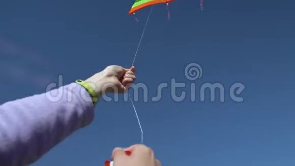 快乐的年轻女子在夏天日落时带着风筝在草地上奔跑视频的预览图