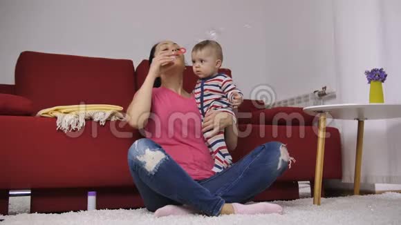 可爱的拉丁妈妈带着宝宝吹泡泡视频的预览图