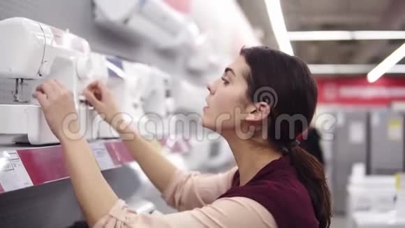 年轻的黑发女孩正在五金店里缝制马什消费者购买家电选择家庭视频的预览图