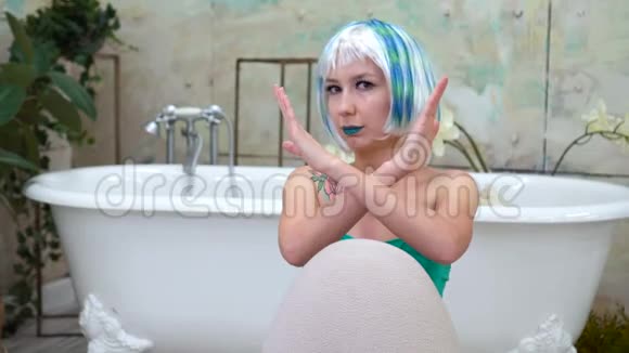 戴假发的女人交叉双臂在浴室里视频的预览图
