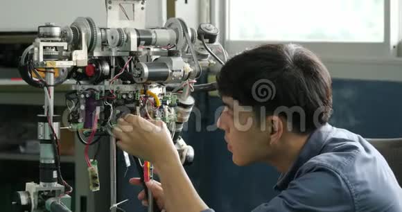 亚洲年轻的电子工程师大楼在实验室修理机器人视频的预览图