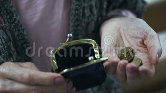 可怜的老妇人因颤抖把硬币放进钱包里而陷入金融危机视频的预览图