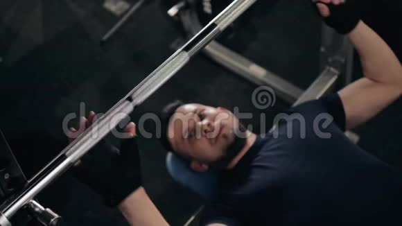 一个强壮的男人的双手滑石粉准备在车库健身房举重室内宏观视频的预览图
