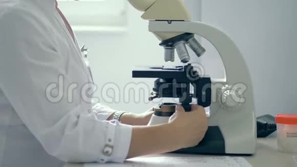 实验室工作人员使用显微镜一个人在实验室里用显微镜工作视频的预览图