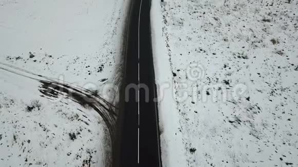冬天的道路上白雪皑皑的田野鸟瞰景色视频的预览图