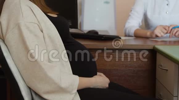 一位年轻的妇产科医生在她的病房里带着怀孕的病人视频的预览图