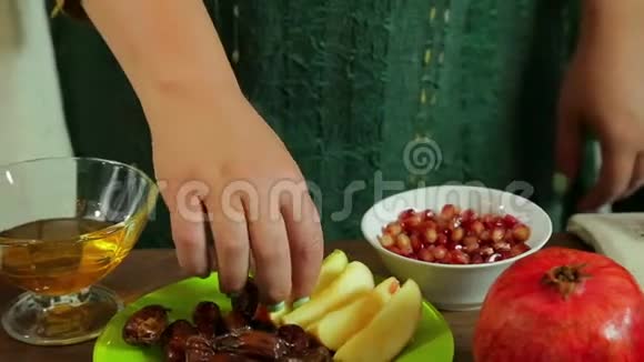 一只雌性手把切好的苹果灌入一杯蜂蜜中视频的预览图