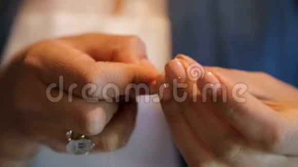 女性双手将希腊坚果整齐地串在绳子上传统美食视频的预览图