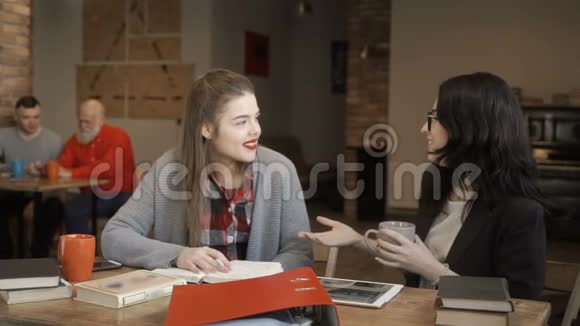 两个女孩在大学准备考试时休息时谈话视频的预览图