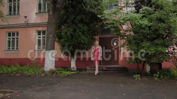穿着红色衣服的模特走在老庭院上视频的预览图