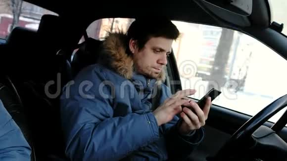 危险的驾驶男人开车看着手机用手机说话视频的预览图
