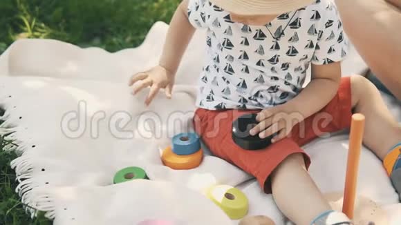 可爱的小男孩在野餐时玩玩具幸福家庭概念视频的预览图