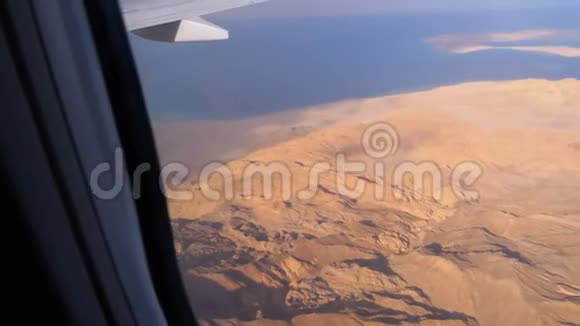 从飞机窗口俯瞰埃及沙漠山脉和红海海水清澈视频的预览图