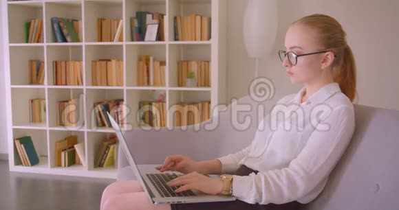 特写侧景照片年轻漂亮的白种人金发女商人戴着眼镜坐在笔记本电脑上视频的预览图