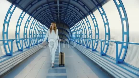 带着旅行袋的年轻商务女性正在从机场或火车站的终点站过渡视频的预览图