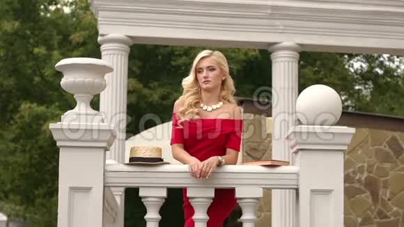 穿红色衣服的女孩正靠在楼梯栏杆上视频的预览图