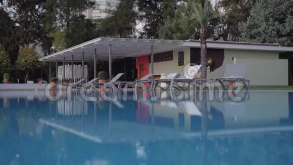 有公寓游泳池和躺椅的度假场景视频的预览图