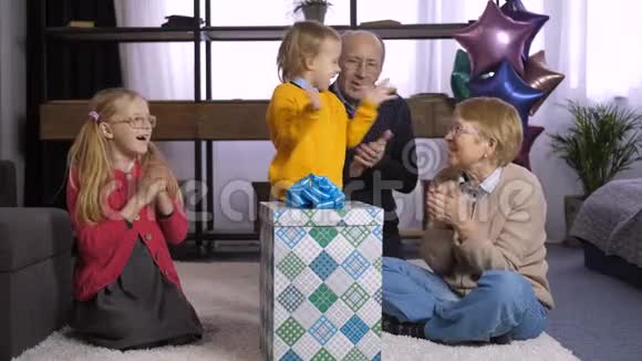 可爱的小男孩打开礼物盒视频的预览图