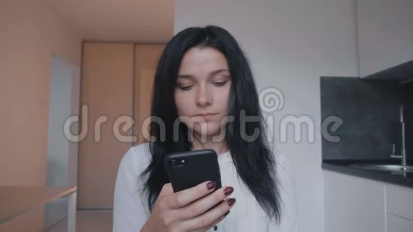 年轻女性黑发在家使用智能手机的画像视频的预览图
