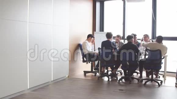 商务人员在开放式办公室内部有一个全景窗口视频的预览图
