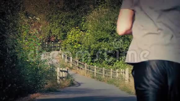 人在穿过公园的小路上奔跑视频的预览图