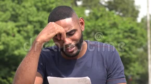 悲伤的黑人阅读一份文件视频的预览图