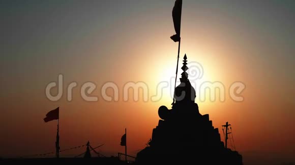 在日出时顶着太阳的山顶上放置的庙宇的剪影视频的预览图