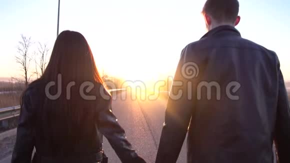 后视为一对相爱的夫妇牵着手慢慢地走向黎明视频的预览图