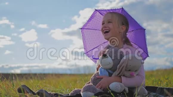 快乐有趣的小女孩带着雨伞和玩具孩子在户外玩大自然儿童梦概念视频的预览图