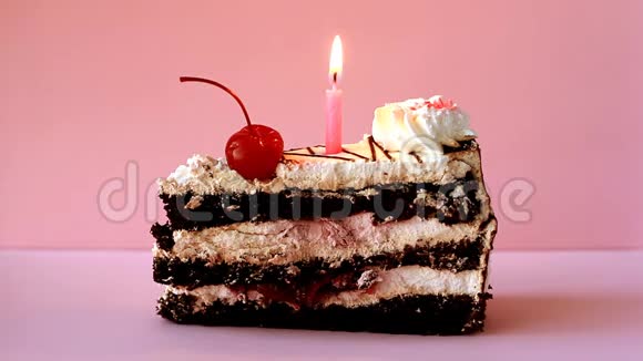 饼干篮上面有白色糕点奶油红色鸡尾酒樱桃和一支燃烧的生日蜡烛视频的预览图