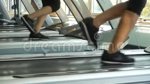 女性的腿在跑步机上跑步在健身房的镜子里反射健身者做有氧运动目标视频的预览图