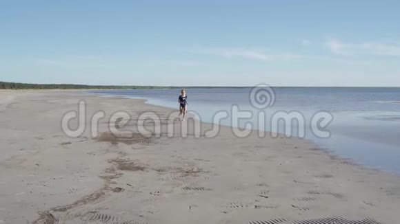 穿着泳装在海边奔跑的年轻女子女孩沿着海边慢跑女游客玩得很开心概念视频的预览图