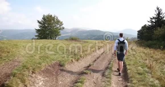 孤独地走在山里一个人走在路上走在一座山上前面有一片壮丽的风景他看着自己视频的预览图