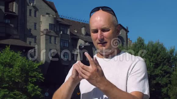 光头男用手机在户外进行视频通话视频的预览图