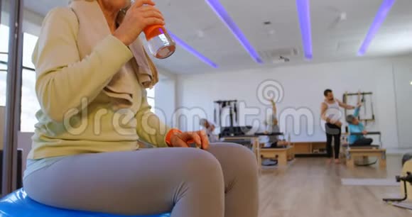 瑜伽中心4k的高级女性饮用水视频的预览图