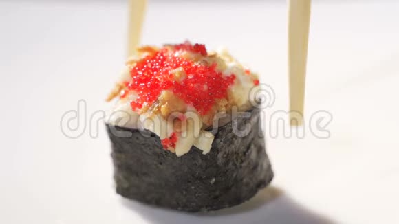 在家里或在寿司吧咖啡厅用筷子在圆木盘上吃寿司的女人的特写镜头视频的预览图