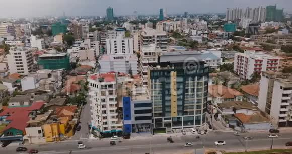 无人驾驶飞机飞越斯里兰卡科伦坡从空中俯瞰城市景观包括建筑物街道交通和小铁路视频的预览图