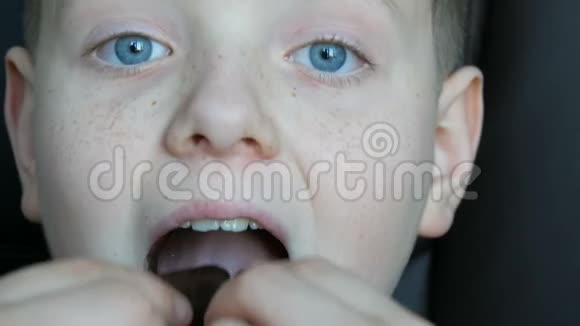 雀斑金发少年蓝眼睛吃巧克力糖闭目养神视频的预览图