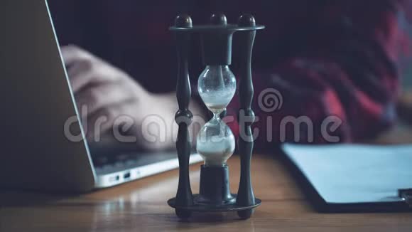 年轻的商业女性在电脑上工作穿着休闲服装衬衫在钟点附近在一个模糊的视频的预览图
