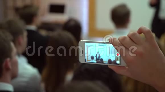 人们在会议或演讲研讨会图片小工具上制造智能手机和平板电脑后景4k业务视频的预览图