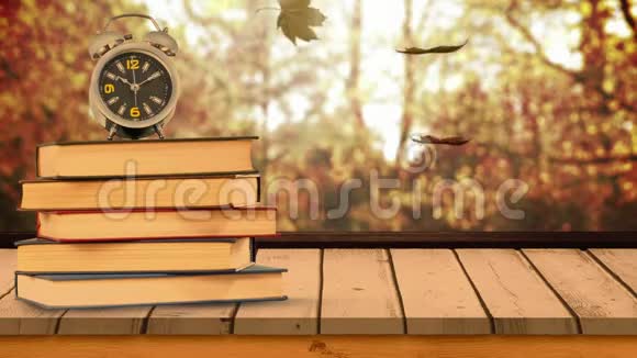 书堆上的钟秋天落叶视频的预览图
