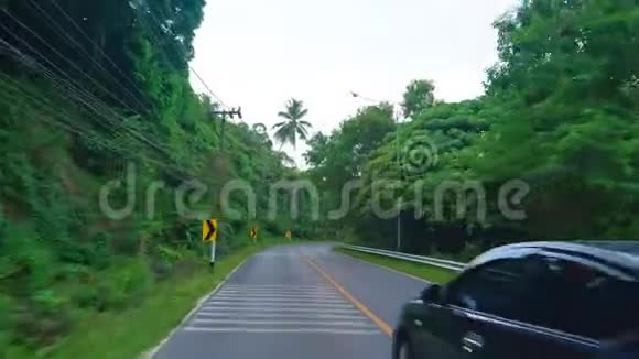 在热带的柏油路上穿过棕榈树视频的预览图