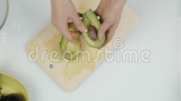 把鳄梨切成碎片切制生菜的水果顶视图4K视频的预览图