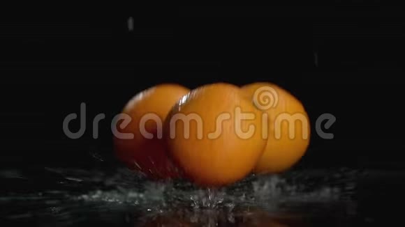 在带有复制空间的黑暗背景下橙子在水中缓慢运动视频的预览图